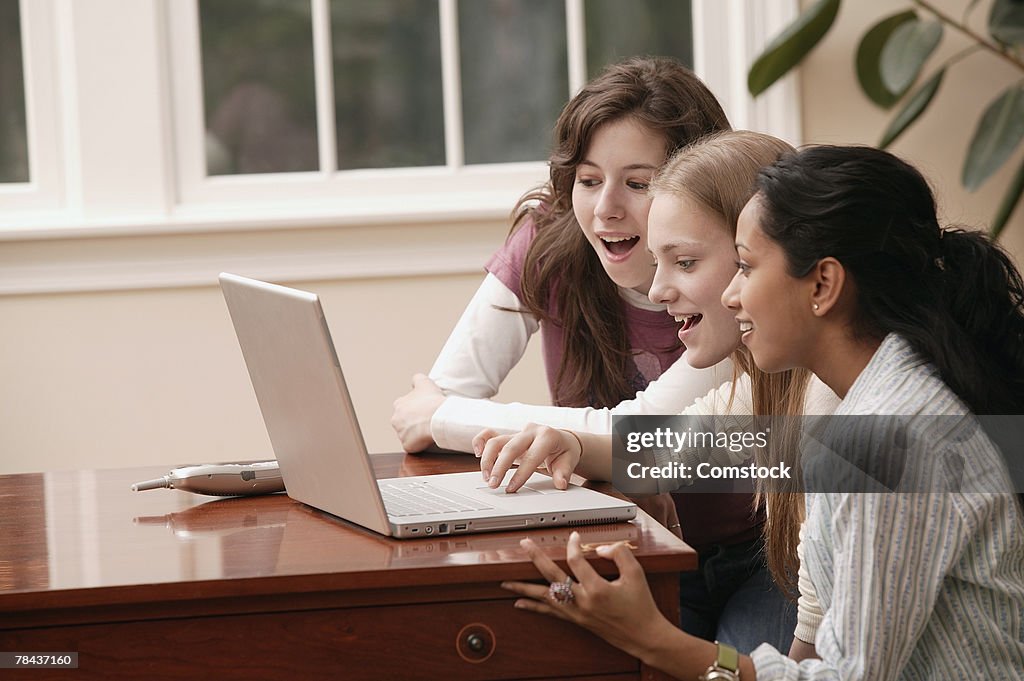 Teenage girls using laptop