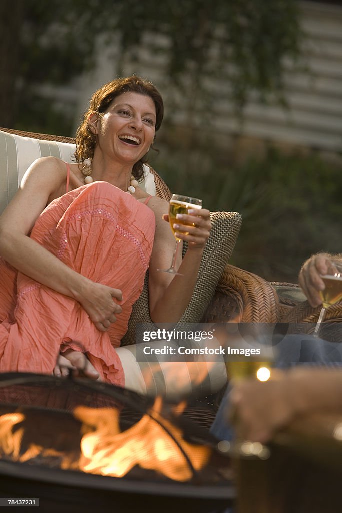 Woman laughing and holding a glass of wine