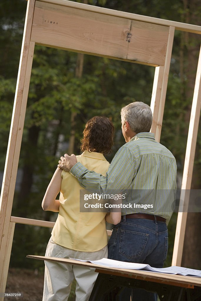 Couple standing at construction site