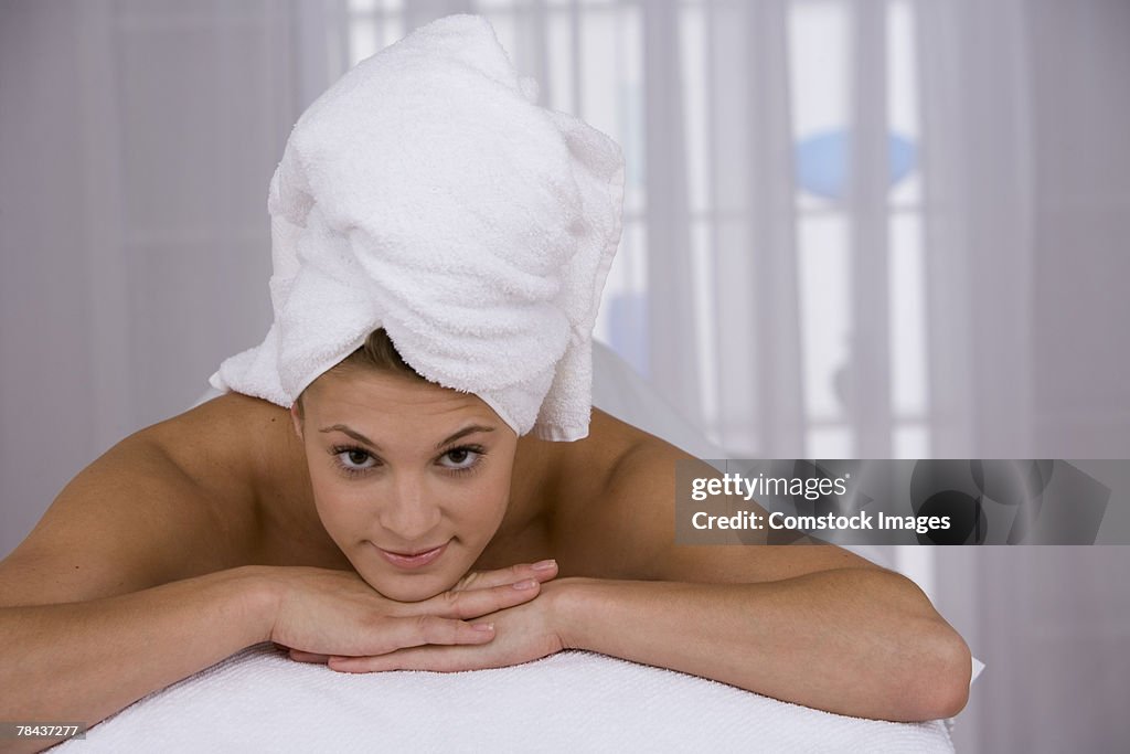 Woman lying down with towel on her head
