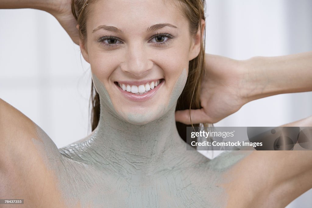 Woman covered in mud treatment