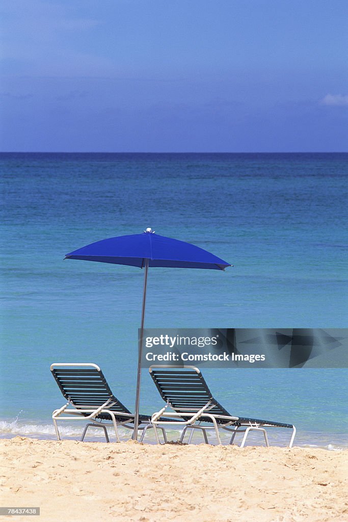 Umbrella and lounge chairs on beach