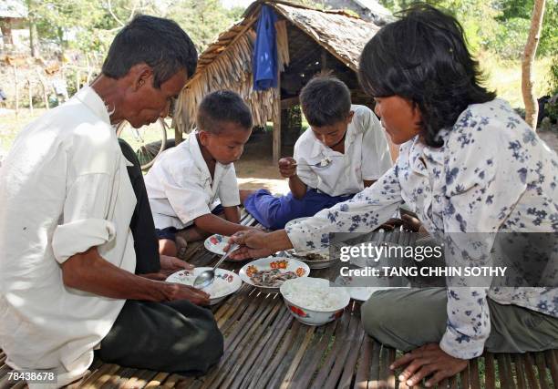 Cambodian HIV-positive family has lunch at their house in Kampong Speu province, some 45 kilometers west of Phnom Penh, 07 December 2007. Cambodia...