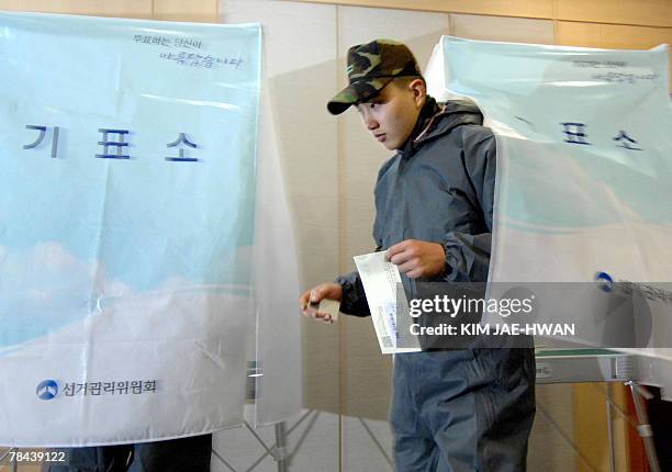 South Korean Army soldier who has been working to remove dense crude oil following the recent tanker spill casts his absentee ballot for the...