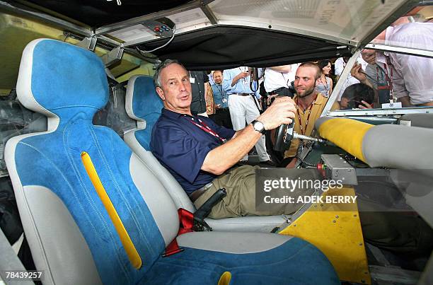 New York City Mayor Michael Bloomberg sits behind the steering wheel of a solar taxi at a hotel near the venue of the UN Climate Change Conference...