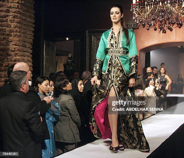 Models displays a kaftan outfit during a fashion show dedicated to the kaftan, Morocco' traditional women clothing on the sidelines of the Marrakech...