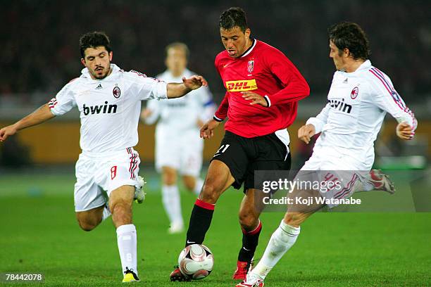 Washington Cerqueira of Urawa Red Diamonds and Gennaro Gattuso and Massimo Oddo of AC Milan compete for the ball during the FIFA Club World Cup semi...