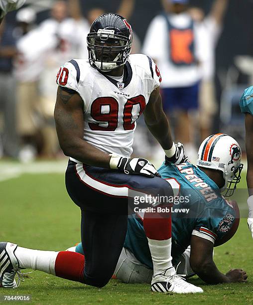 Houston Texans defensive end Mario Williams celebrates after sacking Miami Dolphins quarterback Daunte Culpepper.The Houston Texans defeated the...