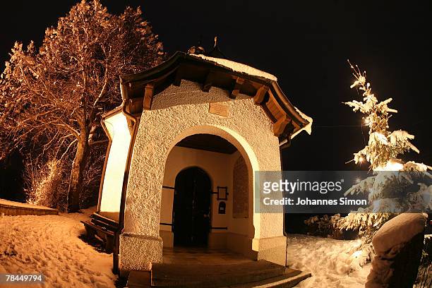 Christmas tree is illuminated in front of an old chapel on December 13, 2007 in Bad Bayersoien, Germany. Snowfall brought winter back to the Bavarian...