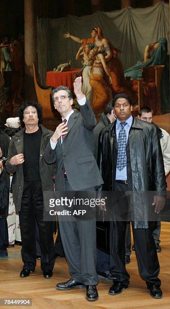 Libyan leader Moamer Kadhafi listens to explaination from museum curator Henri Loyrette as he visits the Louvre museum during his controversial...
