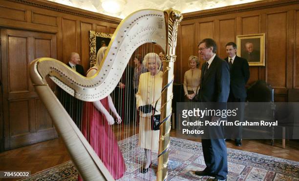 Queen Elizabeth II meets harpist Clare Jones during a visit to the Royal Academy of Music on December 13, 2007 in London, England.