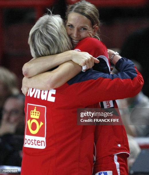 Norway's coach Marit Breivik and player Gro Hammerseng celebrate after their victory 35-24 in the Women World Championships quarter-final handball...