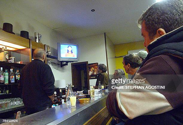 People listen to the announcement of the verdict in the trial of goat herd Yvan Colonna, the alleged killer of French prefect Claude Erignac, 13...