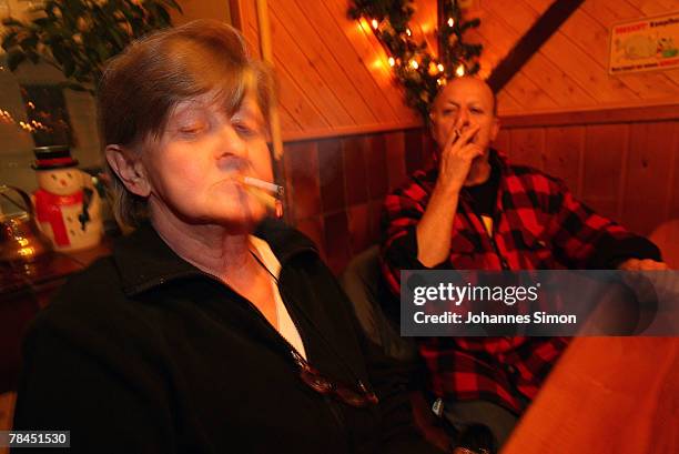 Guests of the pub "Zur Westermuehle" smoke cigarettes on December 13, 2007 in Munich, Germany. The Bavarian Parliament passed a smoking ban law,...