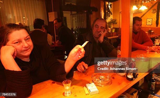 Guests of the pub "Zur Westermuehle" smoke cigarettes on December 13, 2007 in Munich, Germany. The Bavarian Parliament passed a smoking ban law,...