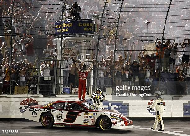 Kasey Kahne, driver of the Dodge Dealers Dodge, gets the checkered flag after winning the NASCAR Nextel Cup Series Coca-Cola 600 on May 28, 2006 at...