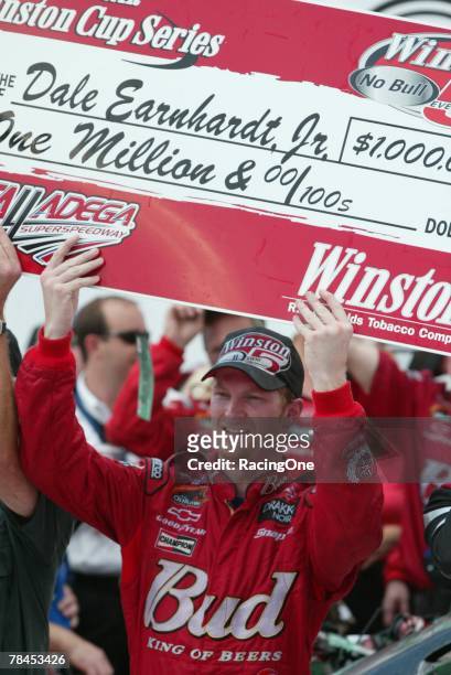 Dale Earnhardt, Jr., driver of the Budweiser Chevrolet, celebrates in victory lane after winning the NASCAR Winston Cup Series EA Sports 500 on...