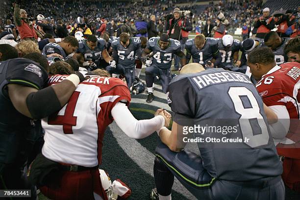 Matt Hasselbeck of the Seattle Seahawks with others pray after the game against the Arizona Cardinals December 9, 2007 at Qwest Field in Seattle,...