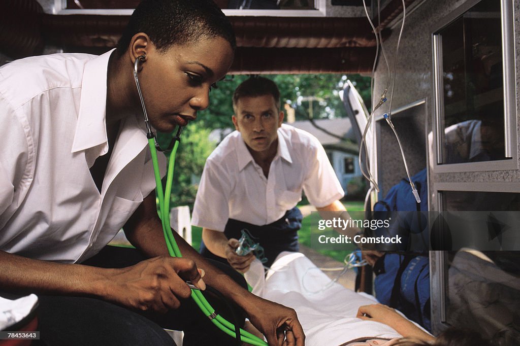 EMTs treating patient in ambulance