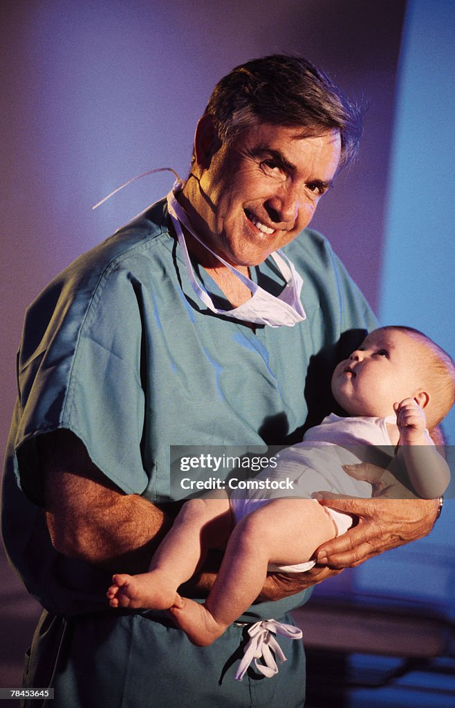 Pediatrician holding baby