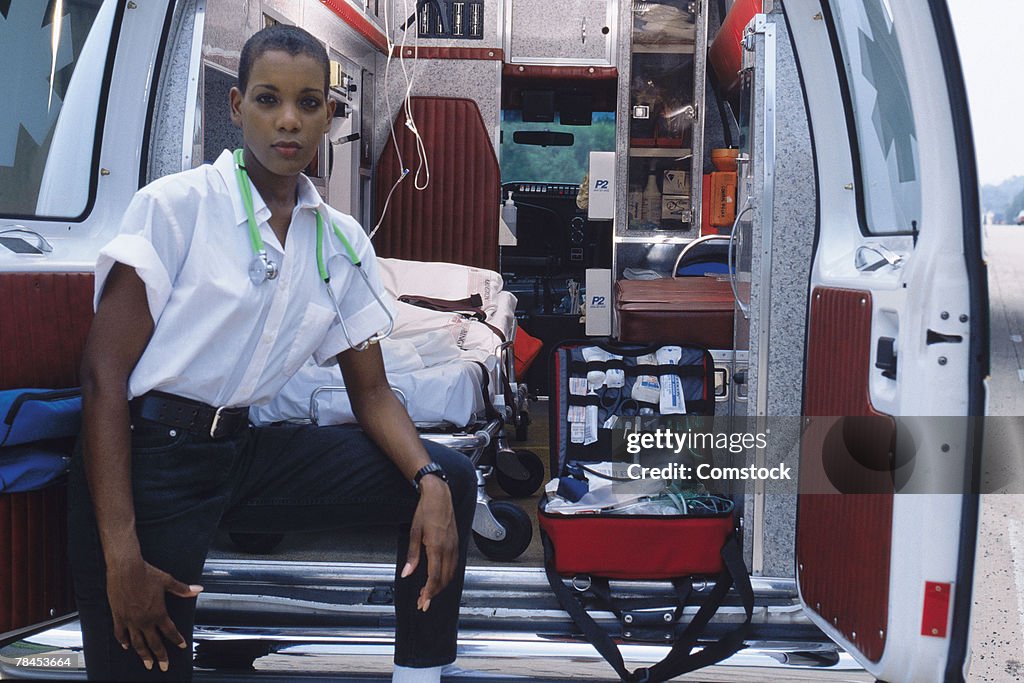 Emergency medical technician at back of ambulance