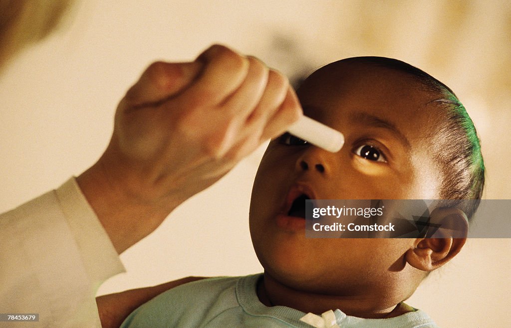 Ophthalmologist giving eye exam