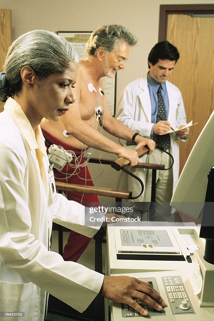 Doctors giving stress test to male patient
