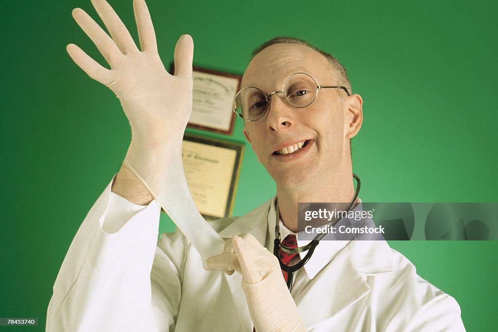 Doctor pulling on gloves