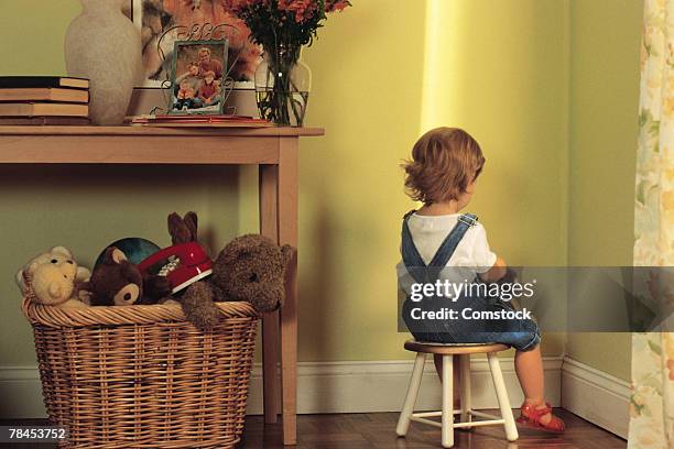 young child sitting in corner as punishment - penalty ストックフォトと画像