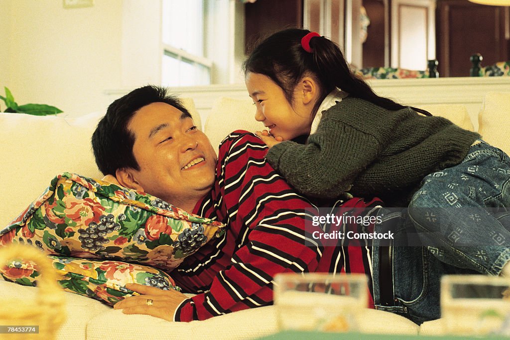 Father and daughter on sofa