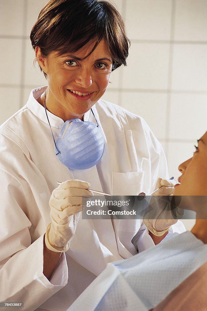 Dentist or dental hygienist with patient