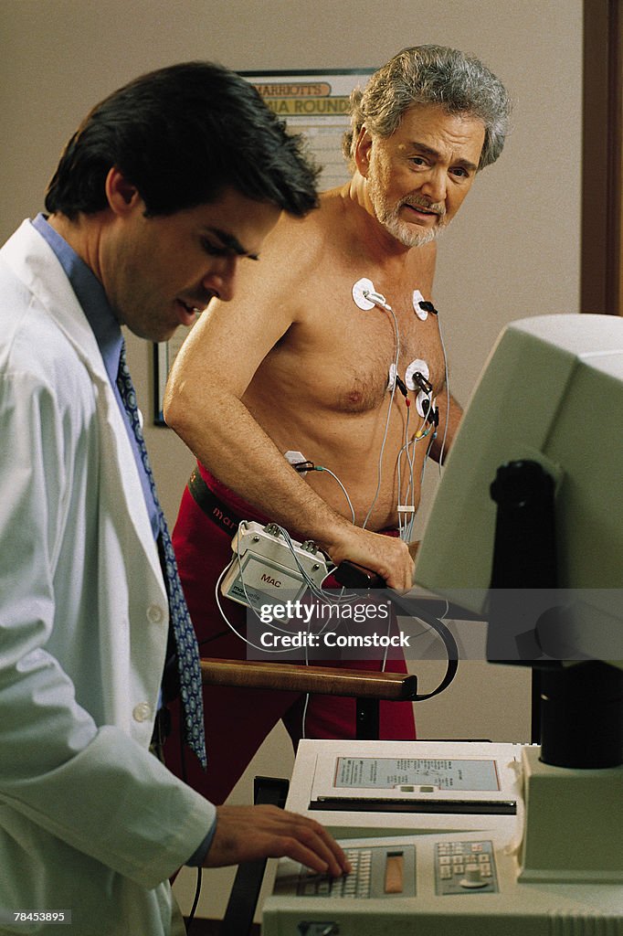 Doctor giving mature man a stress test