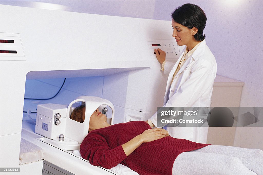 Female doctor with patient in MRI machine