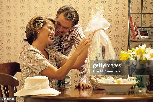 man giving woman an easter basket - gift baskets stock pictures, royalty-free photos & images