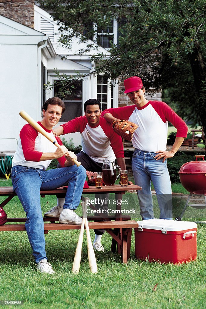 Men posing in baseball jerseys