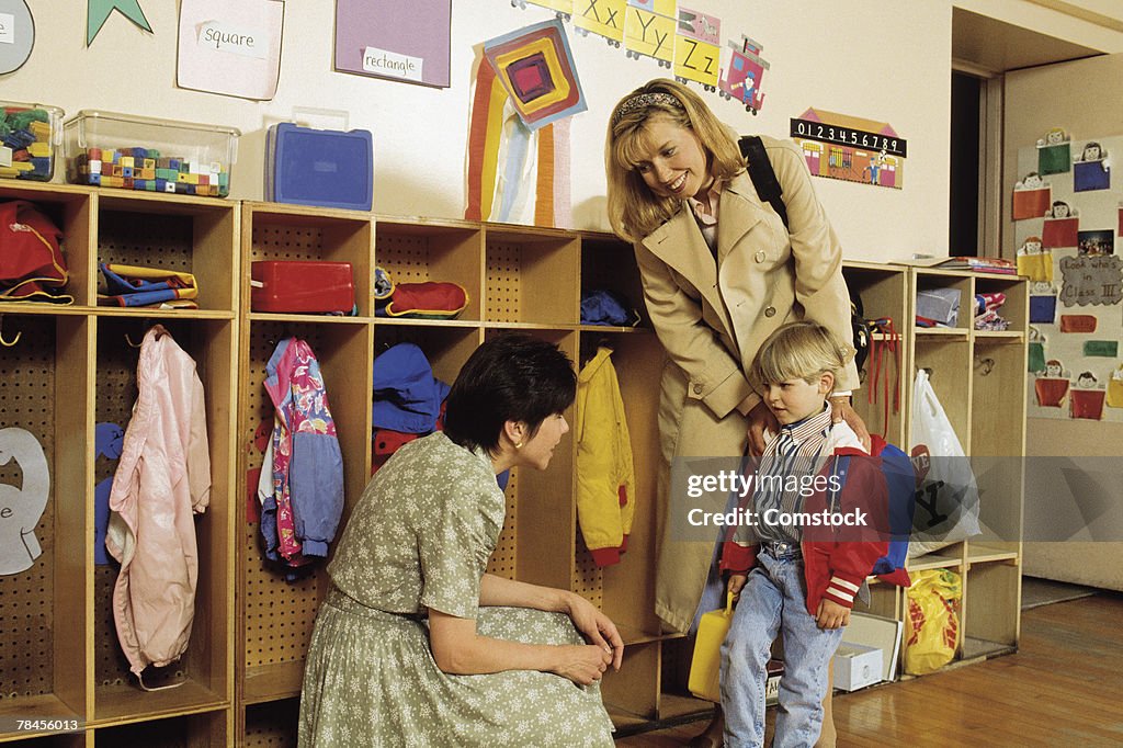 Mother and son in classroom meeting new teacher