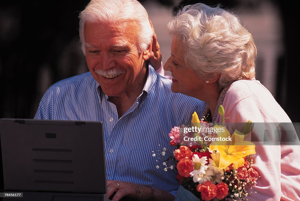 Man and woman using laptop computer