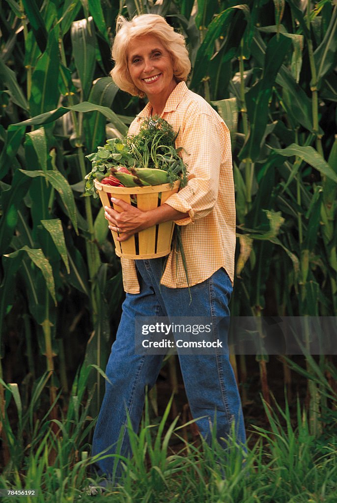 Woman walking with basket of fresh vegetables