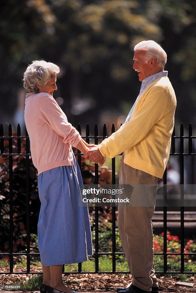 Couple holding hands outdoors