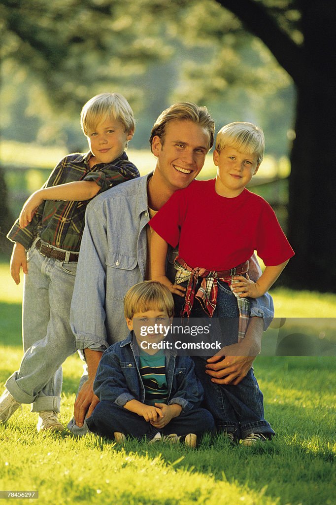 Father and sons posing outdoors