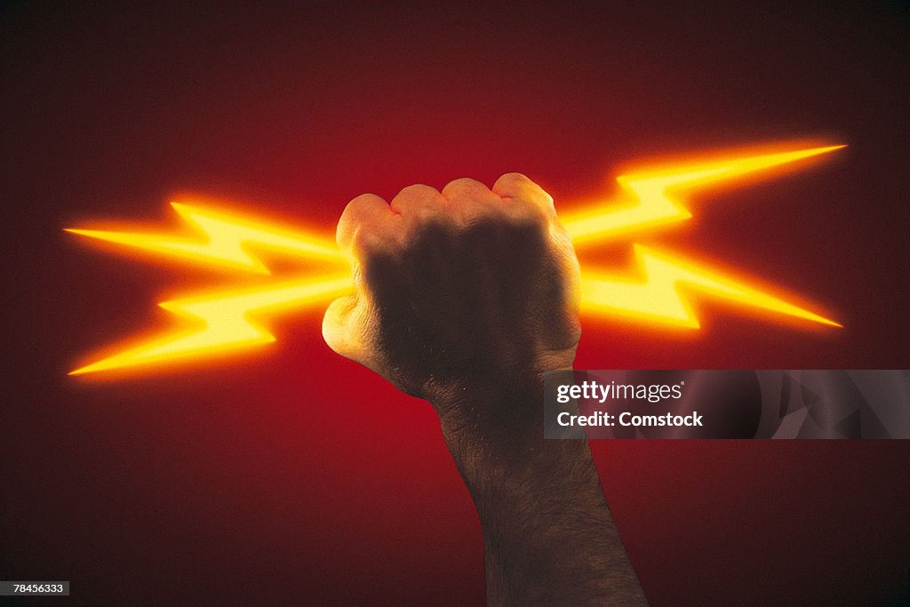 Hand holding lightning bolts