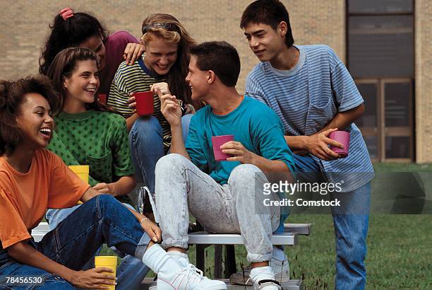 group of teens hanging out together - 90s teens stock-fotos und bilder