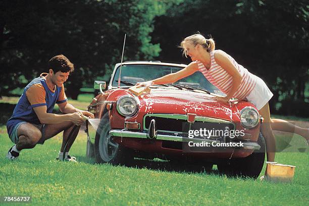 couple washing car - 2000 car stock pictures, royalty-free photos & images