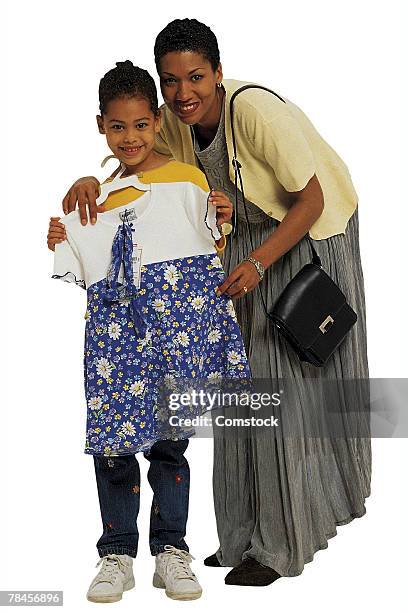 mother with daughter showing new clothes - the mama 90s stock pictures, royalty-free photos & images