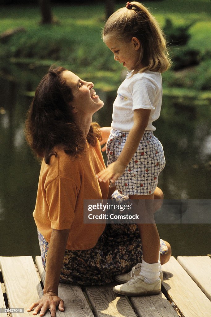 Mother with daughter on dock