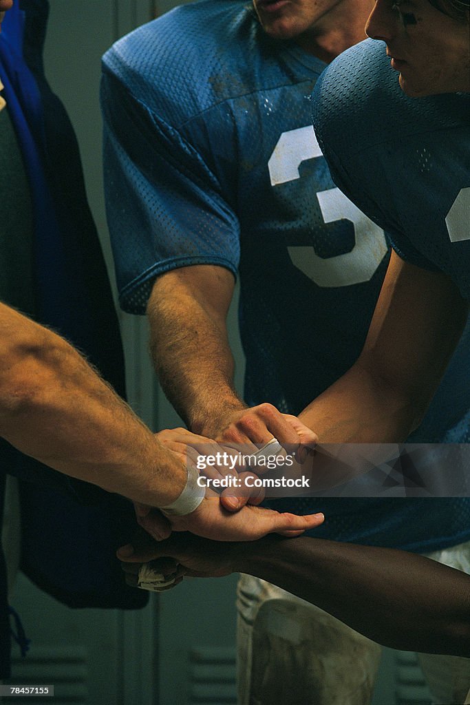 Football players in locker room huddle