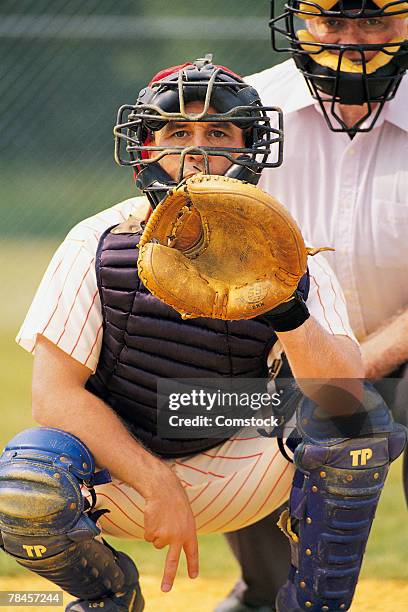 baseball catcher signals pitch - baseball catcher stock pictures, royalty-free photos & images