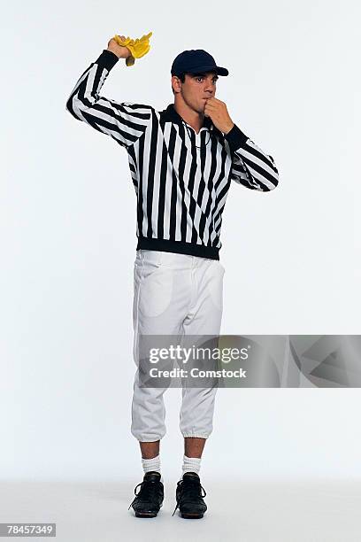 referee waving flag and blowing whistle - referee flag stock pictures, royalty-free photos & images