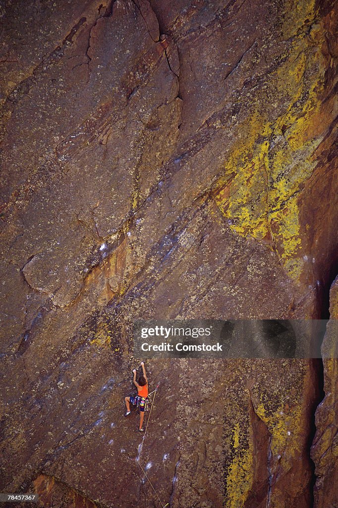 Person climbing on wall of mountain