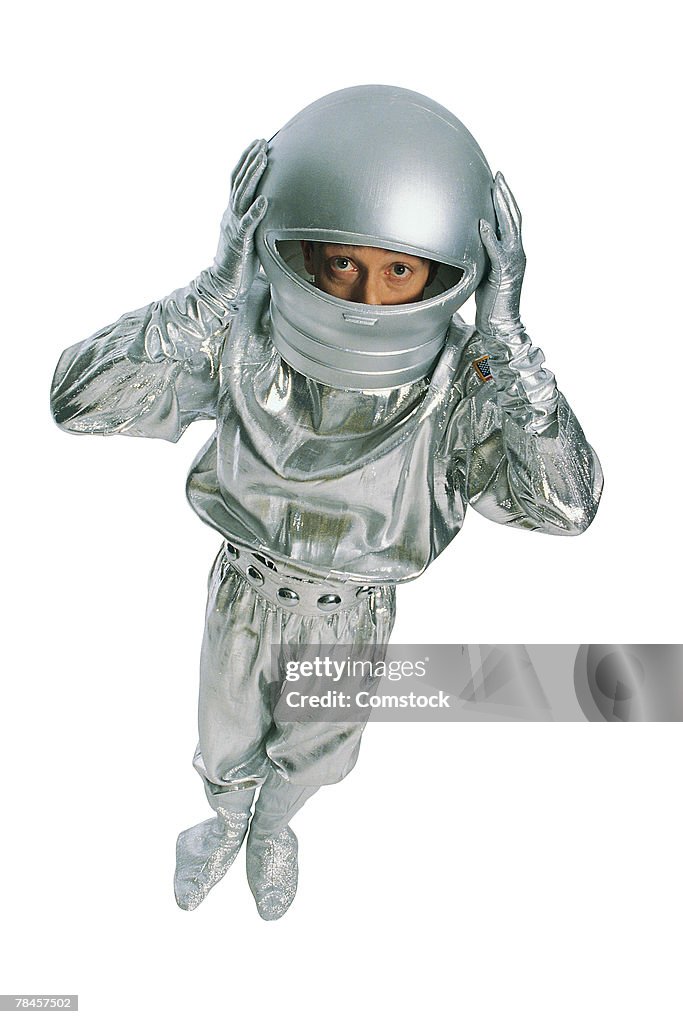 Astronaut with hands on helmet